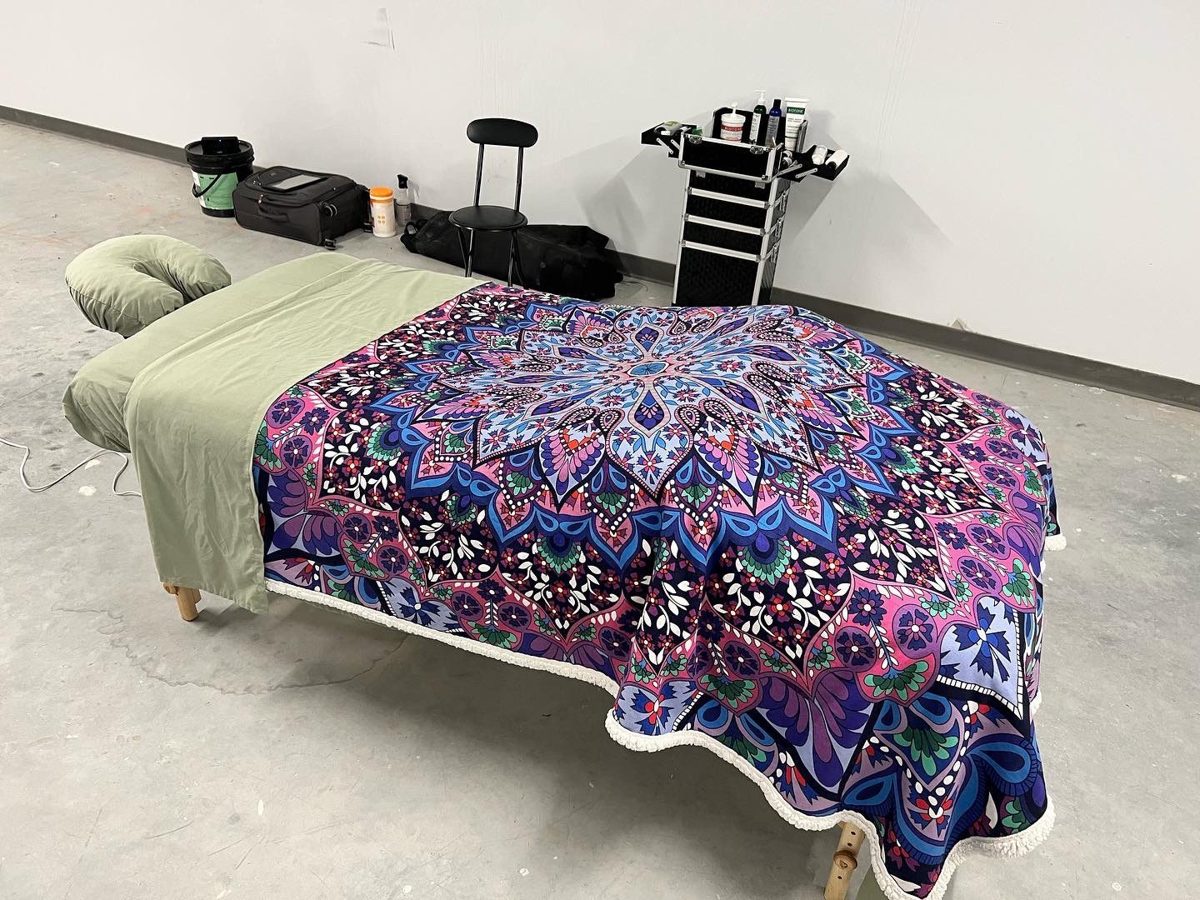 Massage table with a mandala blanket set up for a mobile visit
