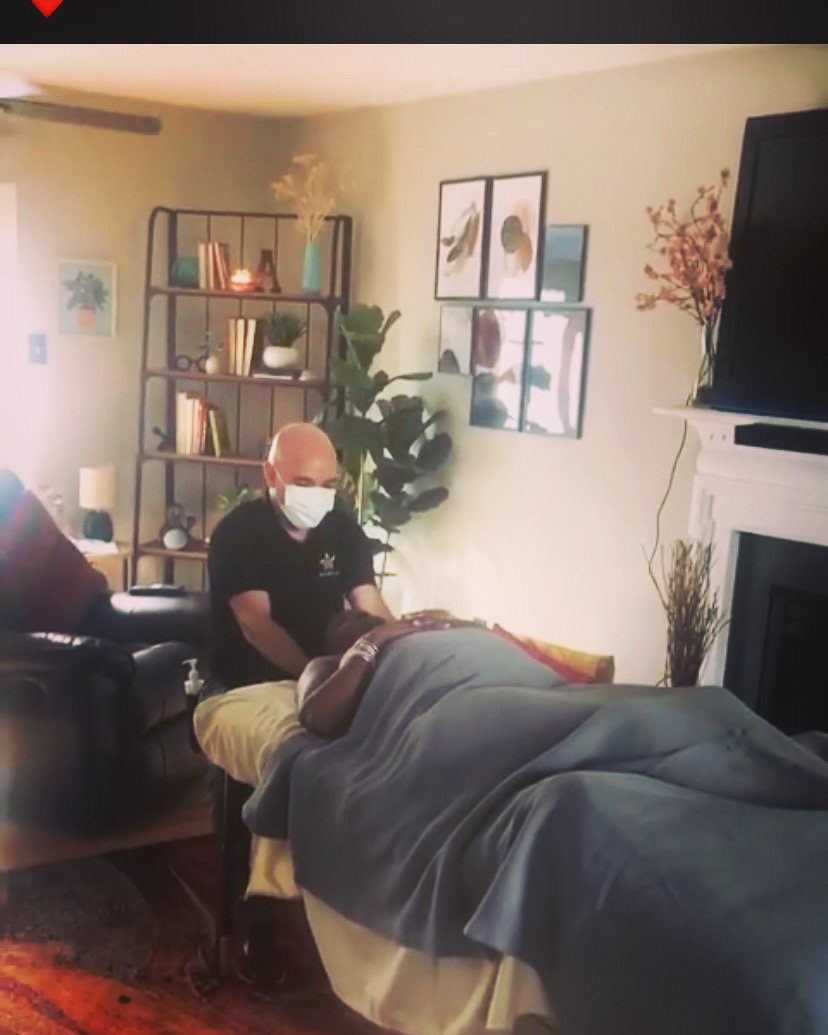 Ryan giving a massage in a client's home