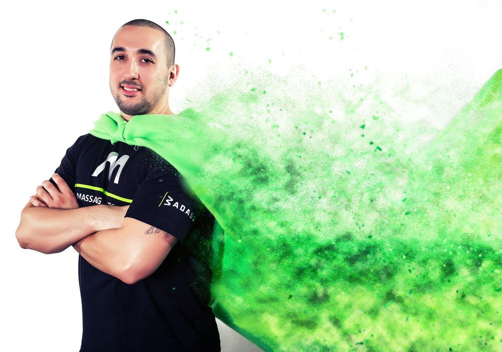 Michael Ortiz Jr., arms crossed, in a burst of green