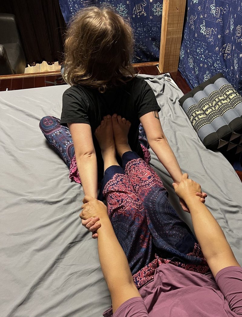 A Thai stretch session on a floor mat in one of D-CHAI's rooms