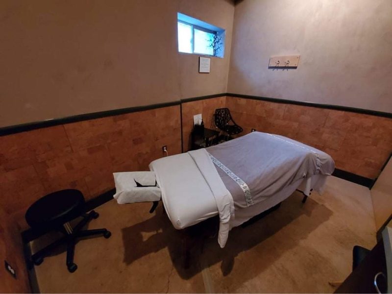 One of the spa's treatment rooms, a massage table made up with fresh linens