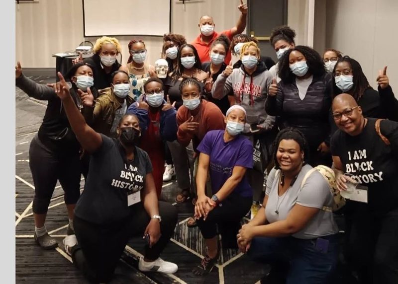 A large class group photo, many in masks, some holding skulls