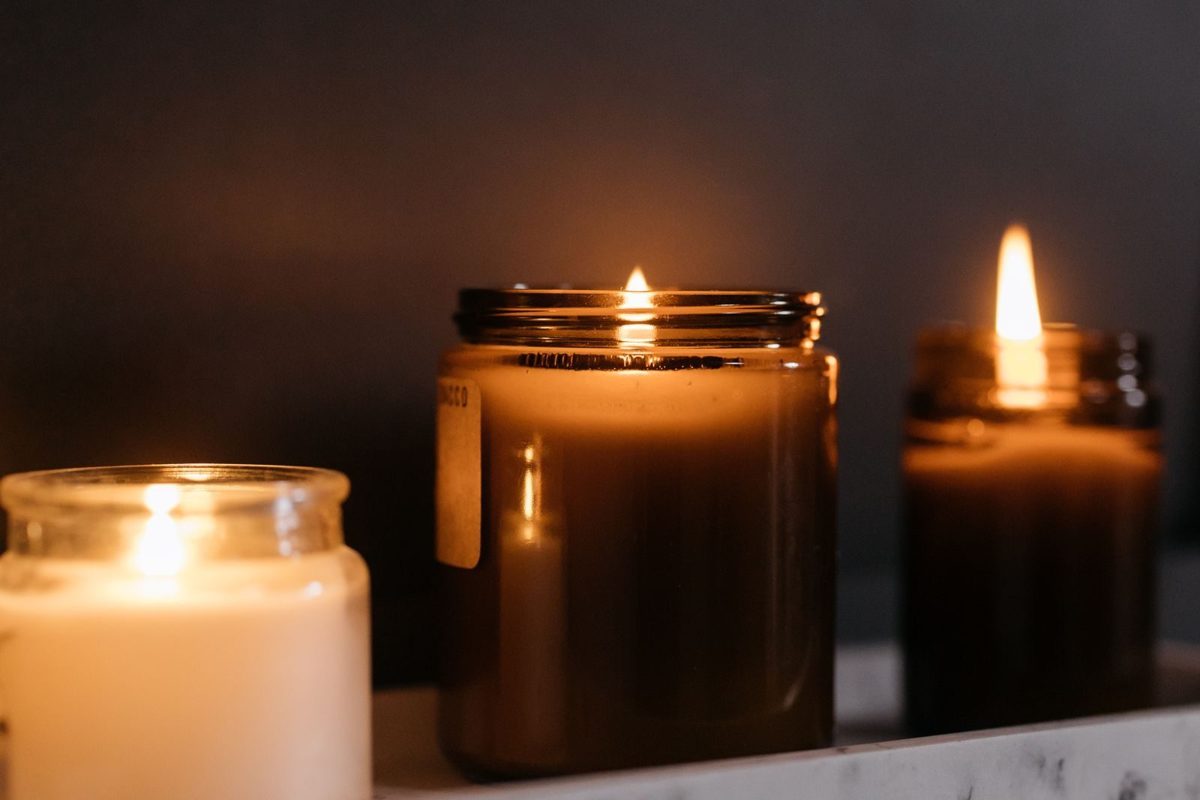 Candles glowing in glass jars
