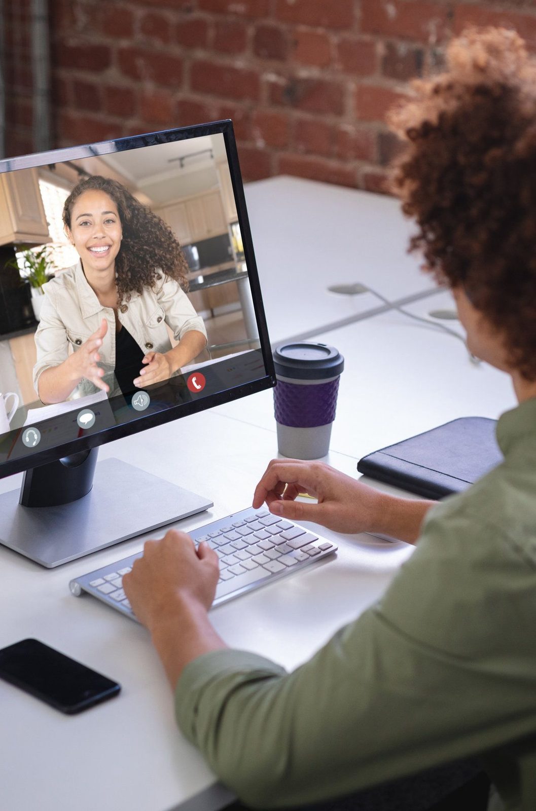 African american afro businessman briefing work to female colleague through desktop pc in office